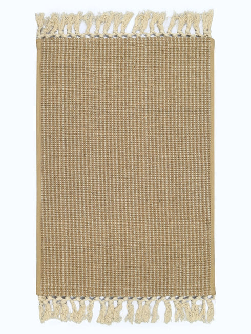 Beige woven placemat with tassels on a white background